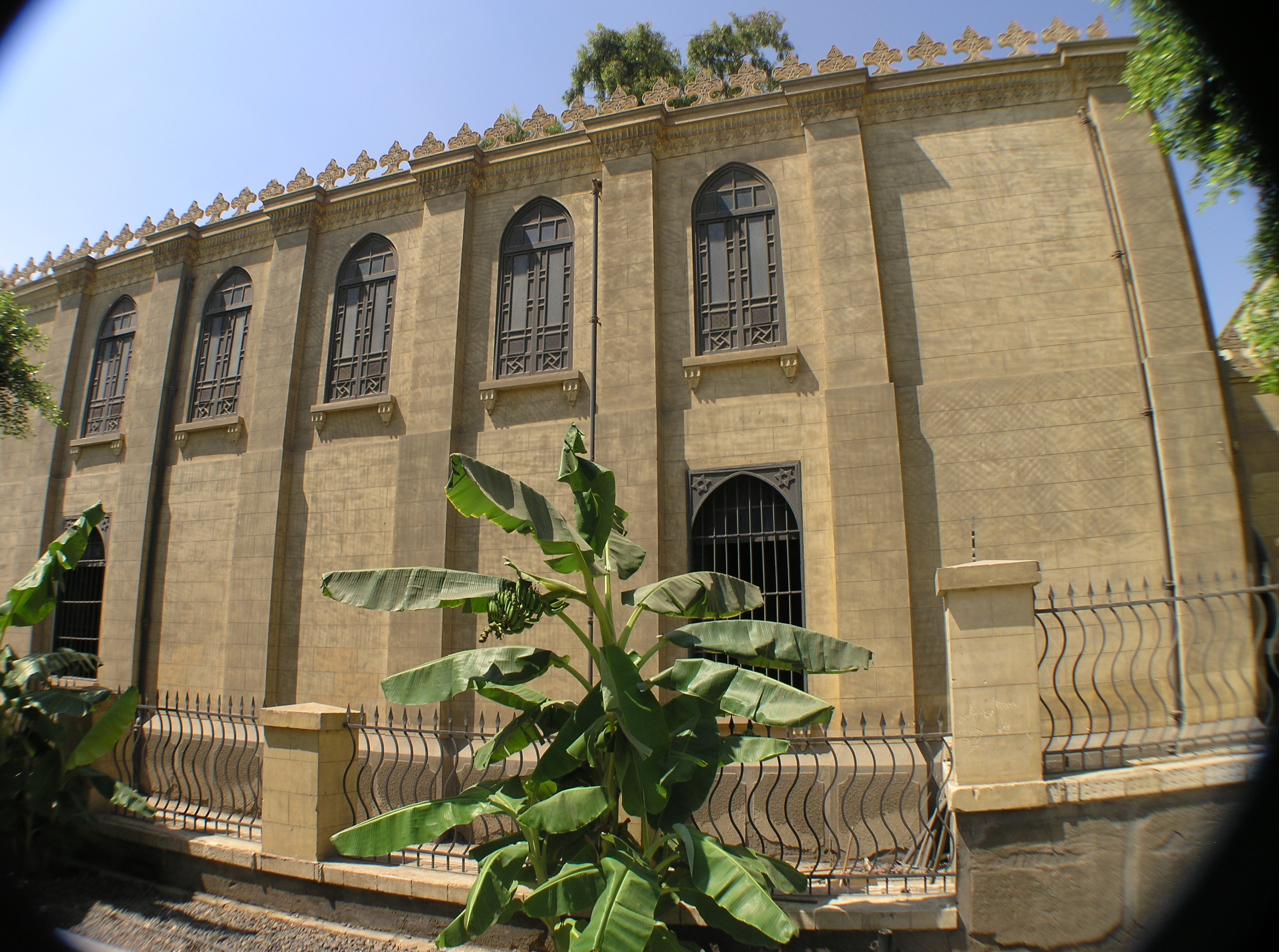 The exterior of the Ben Ezra Synagogue in Old Cairo, with tall arched windows and a decorative cornice