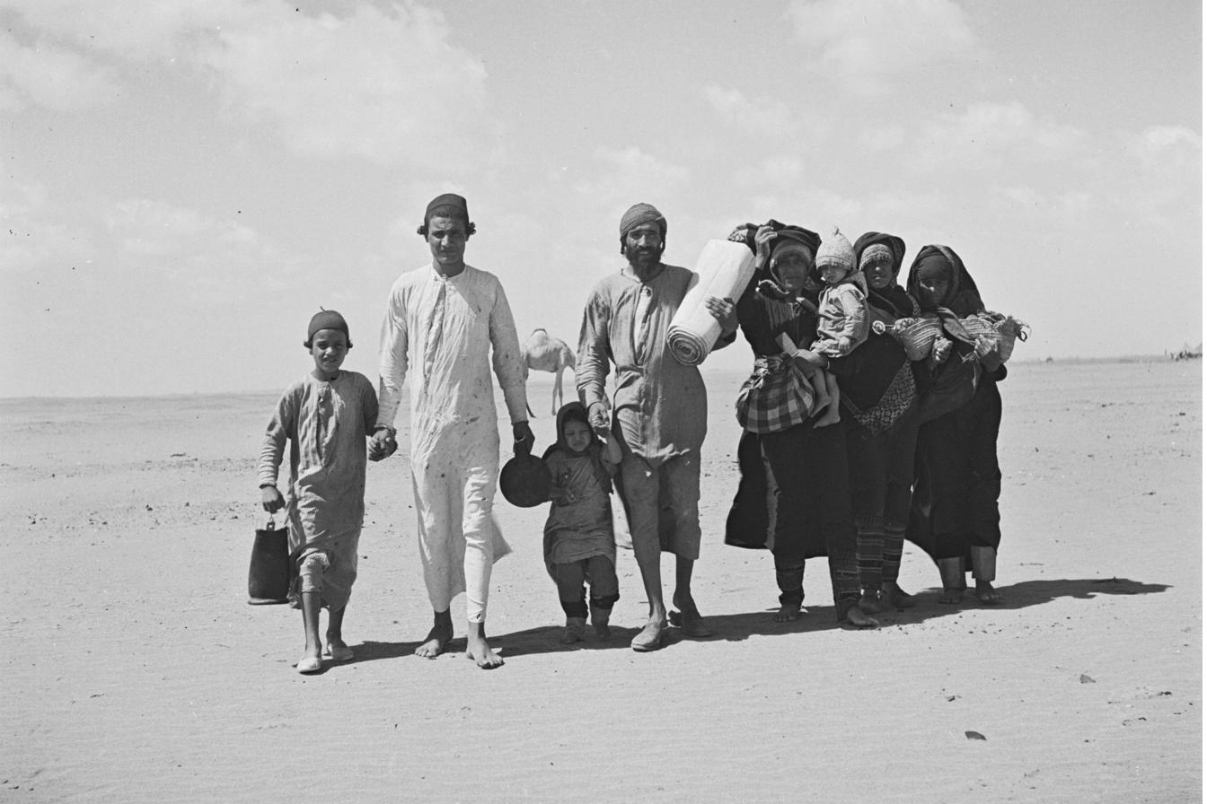 Yemenite Jewish family walking through the desert to a Joint Distribution Committee reception camp near Aden, 1949