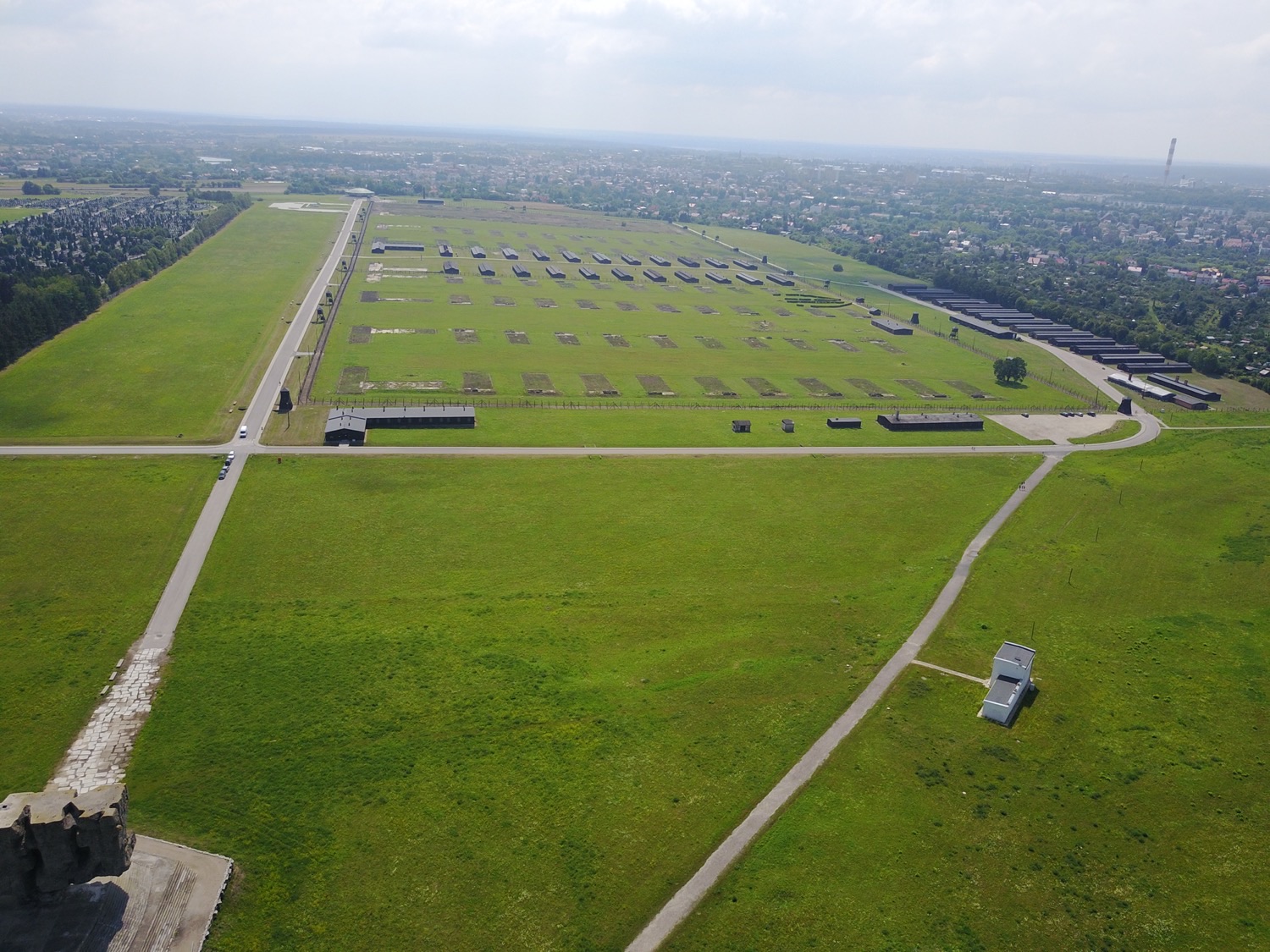 An aerial view of the preserved Majdanek camp grounds, with the rows of barracks and the city of Lublin spreading out directly behind it.