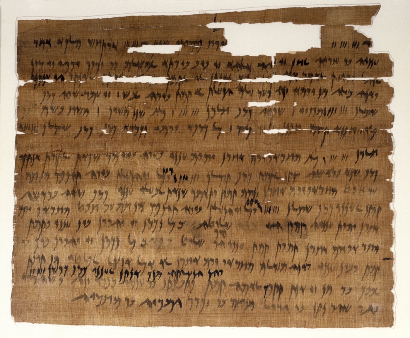 A folded and tied ancient Aramaic papyrus document with ink writing, an Elephantine marriage contract.