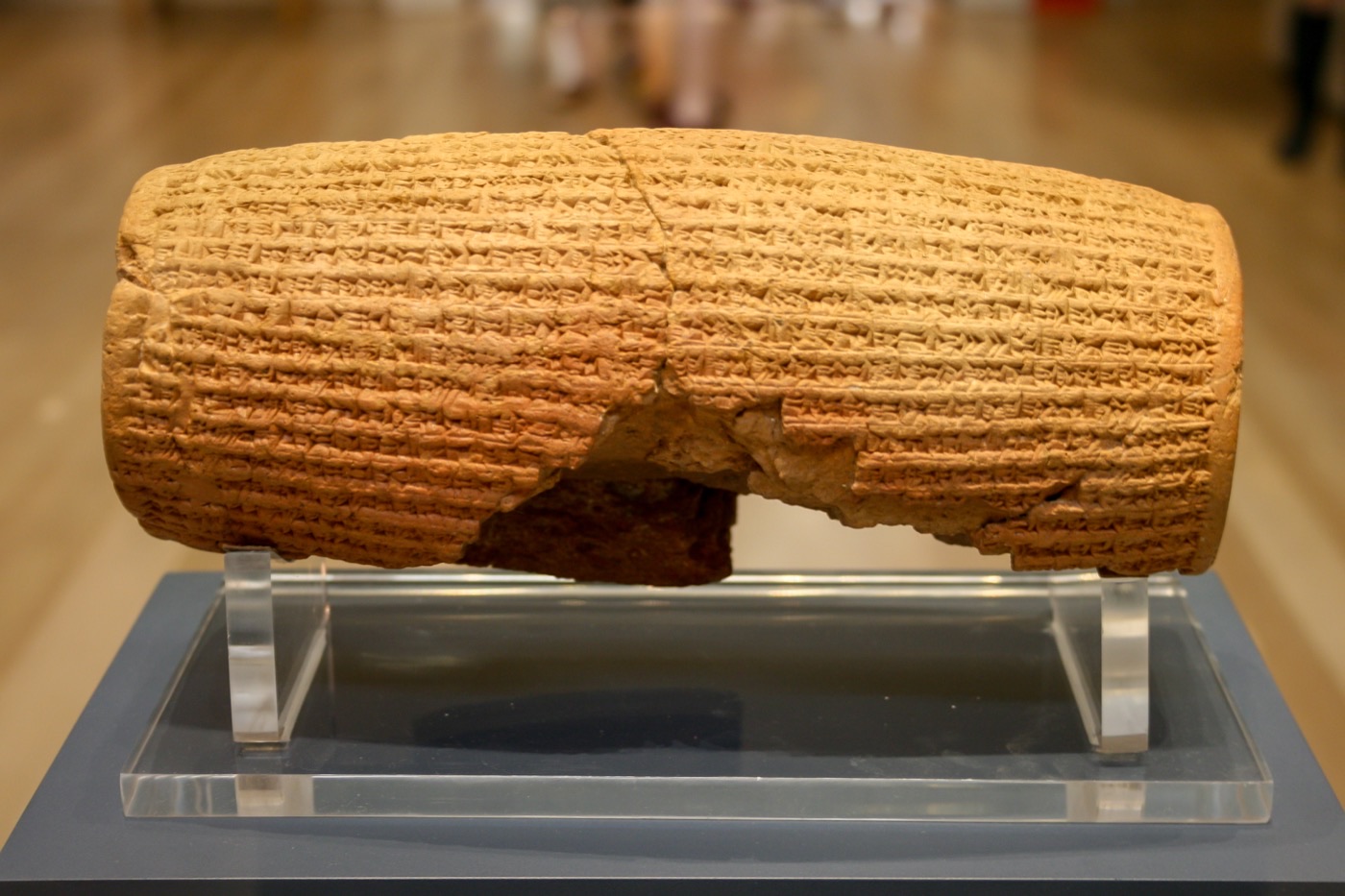 The Cyrus Cylinder, a barrel-shaped clay artifact covered in cuneiform inscription, on display at the British Museum.