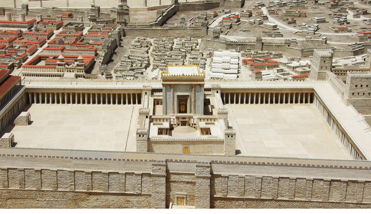 A detailed scale model of ancient Jerusalem seen from above, with a large columned temple complex at the center surrounded by a dense city of pale stone buildings.