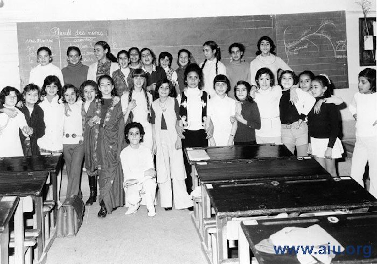 A class of girls standing together in front of a chalkboard at a school in Morocco