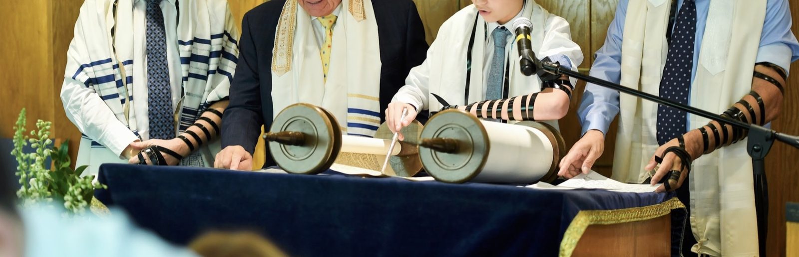 A bar mitzvah reading from the Torah scroll