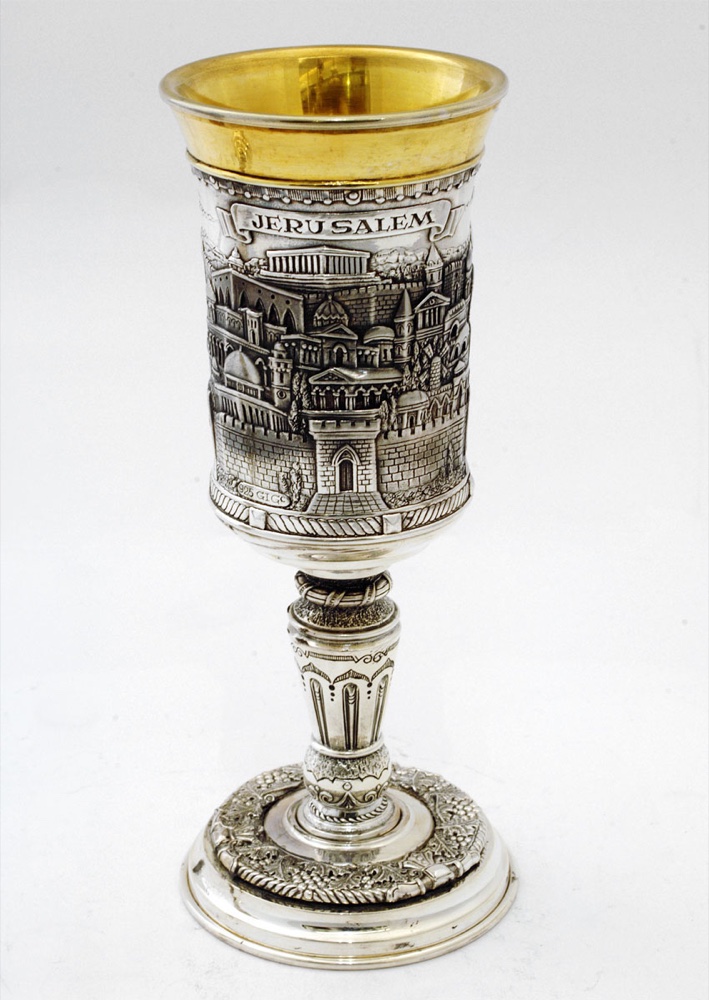 A silver Kiddush cup with a gold-washed bowl and a relief band showing Jerusalem