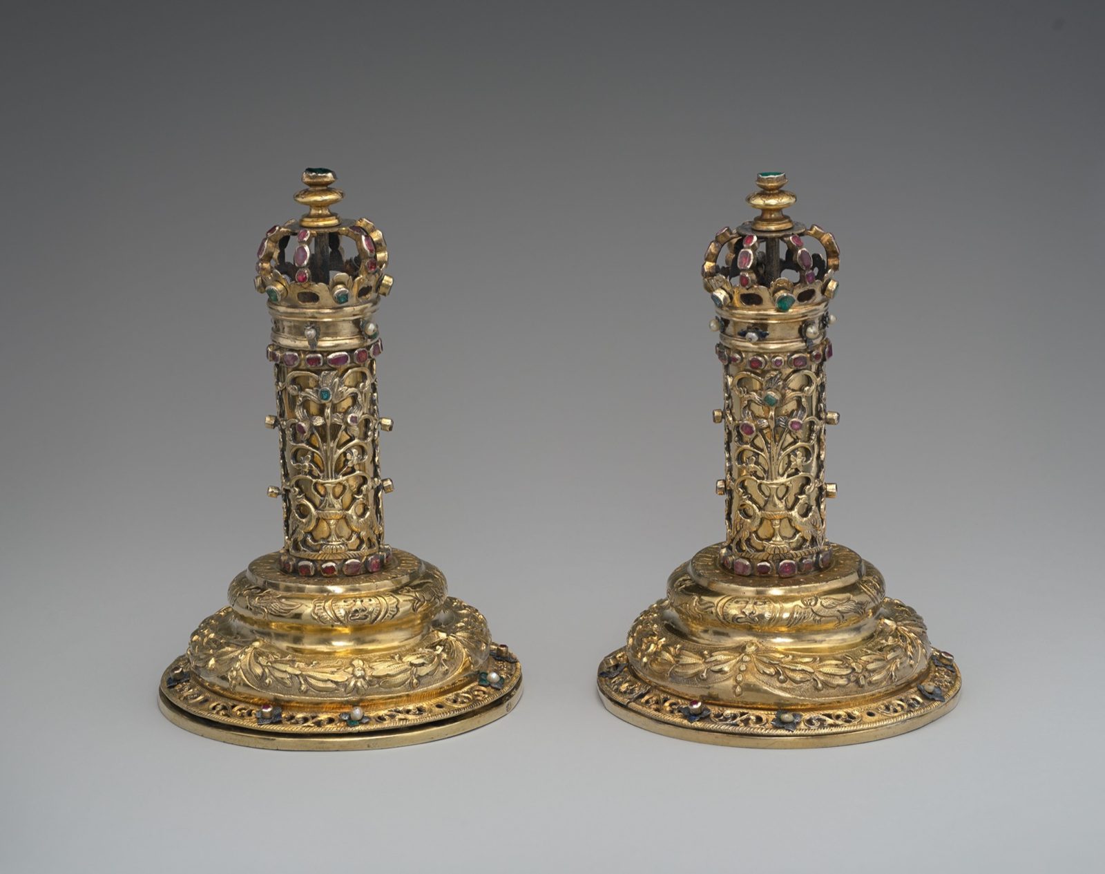 A pair of gilt-silver Torah finials shaped like crowned towers, set with colored stones