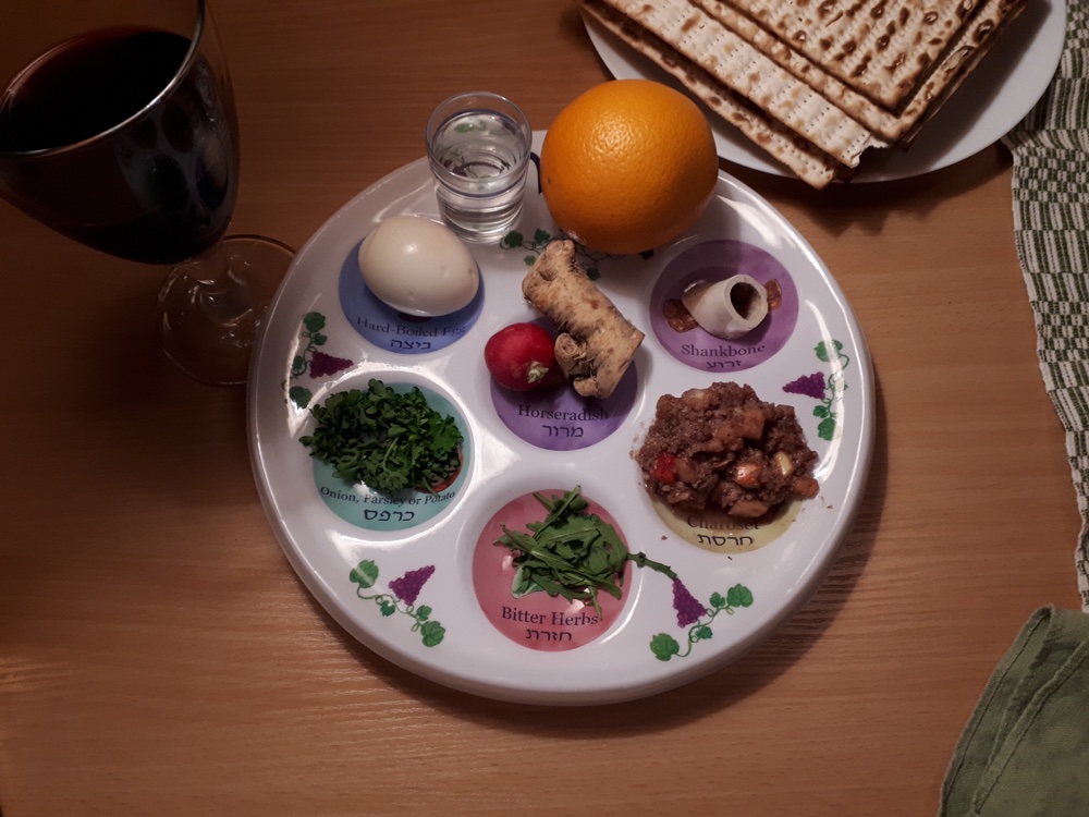 A Passover seder plate with labeled compartments holding the symbolic foods