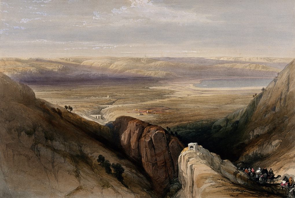 A 19th-century coloured lithograph of the descent into the Jordan valley: rocky cliffs in the foreground, a small caravan on the path, and the broad valley floor stretching to the Dead Sea in the distance.