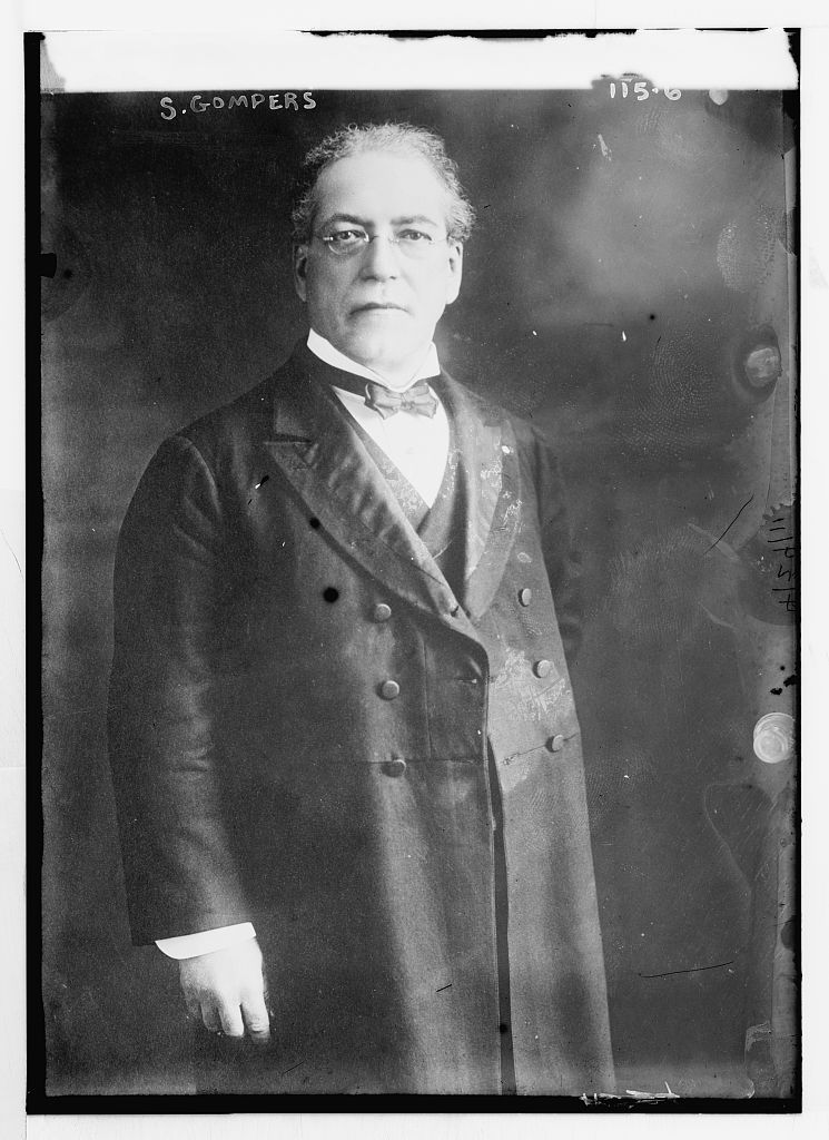 Samuel Gompers in 1911, a stocky man with rimless glasses and a high collar, looking directly at the camera