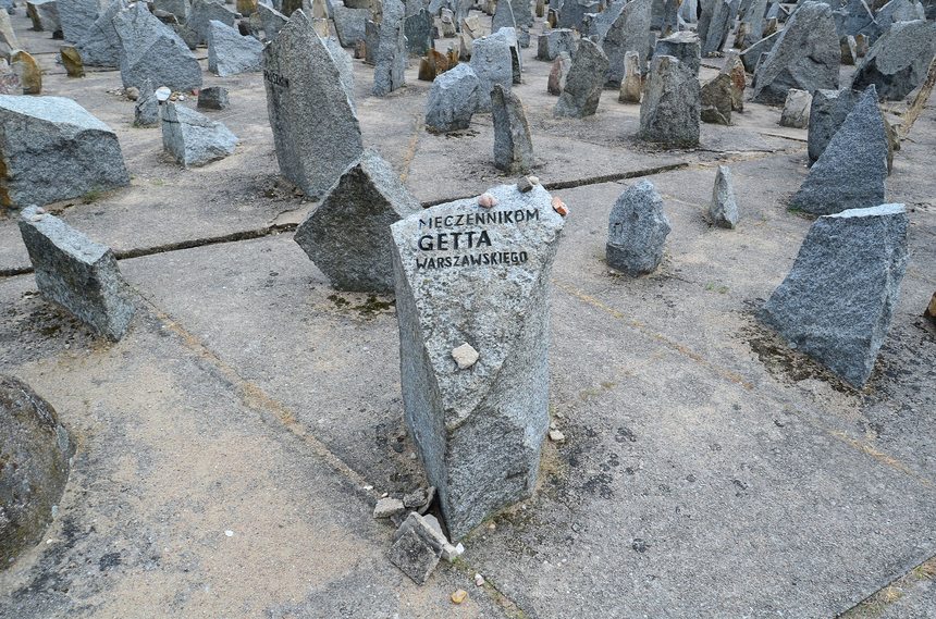 The Treblinka memorial: a tall central monument rising from a field of upright stones.