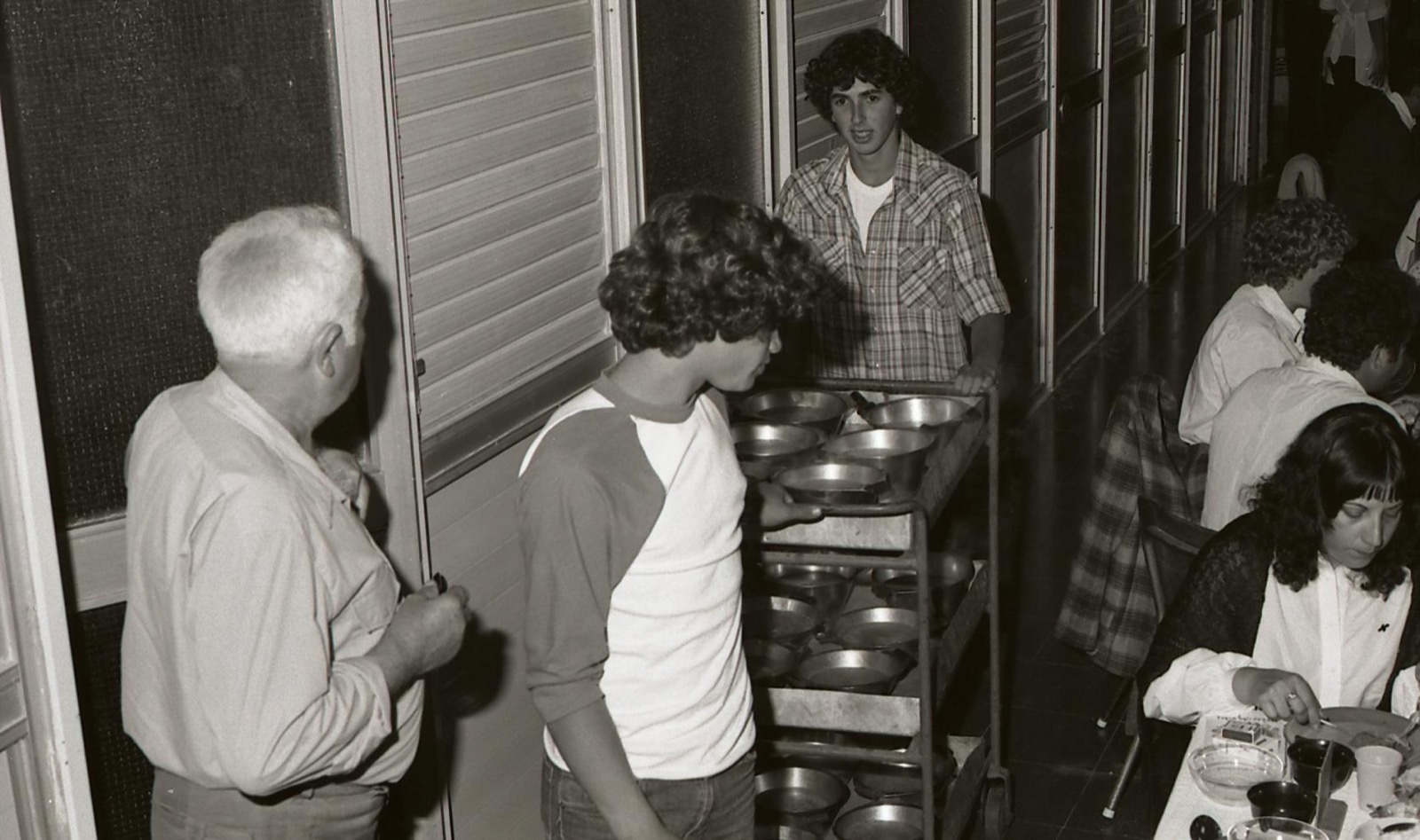 Teenagers serving a communal meal at Kibbutz Geva